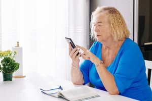 elderly-woman-checking-text-messages-DFU3P92